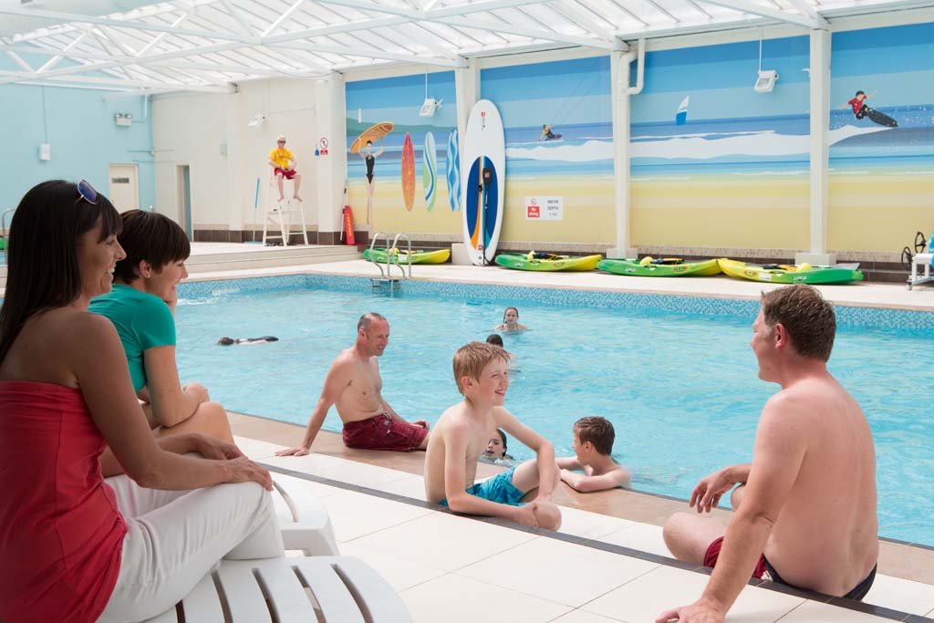 Family enjoying the swimming pool at an accessible holiday park in Cornwall